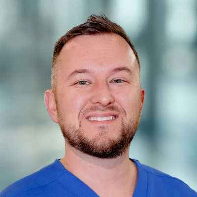 Chiropractor Daniel Roach Smiling Warmly Greeting Patients