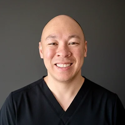 Chiropractor David Miyasaki Smiling Warmly Greeting Patients